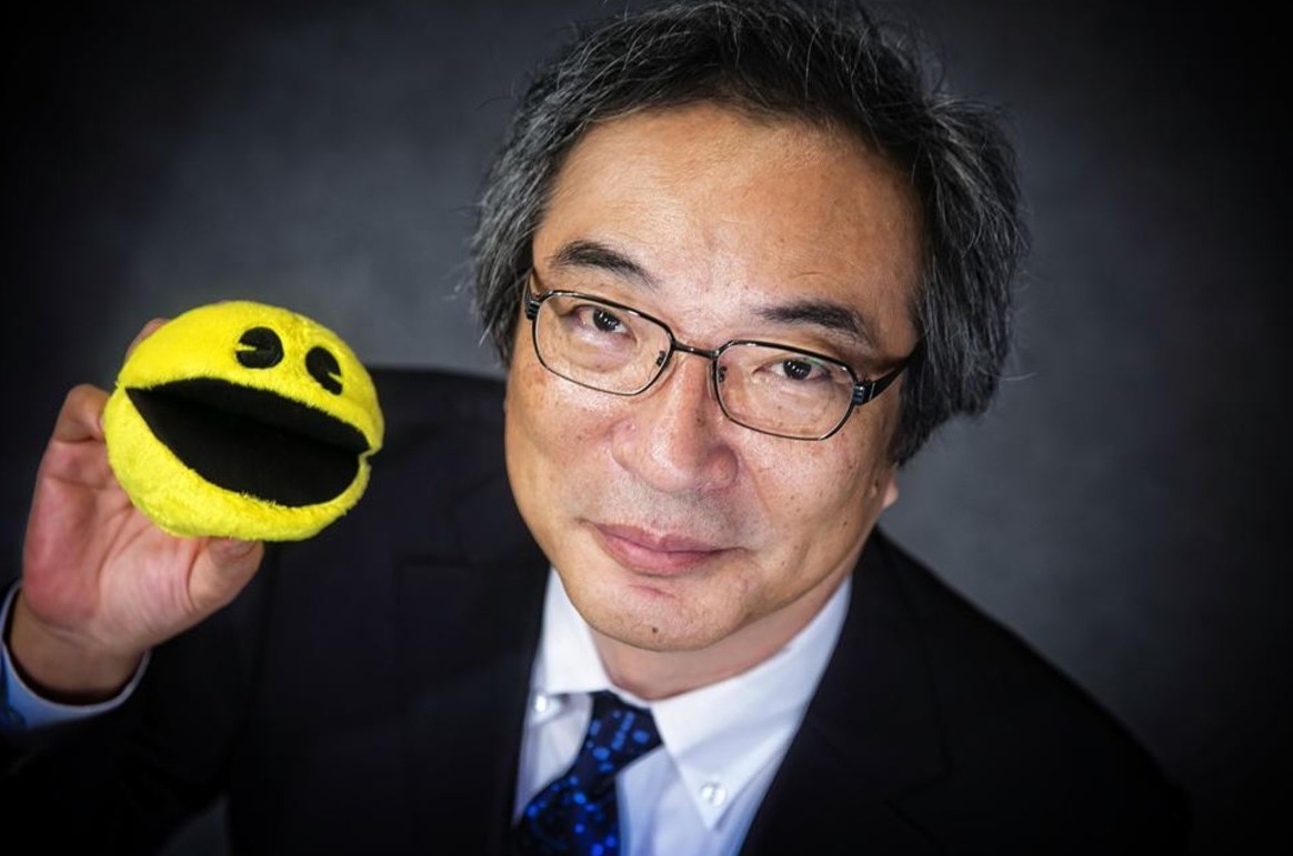 Pac-Man creator, Toru Iwatani, with a soft toy version of his creation in hand.